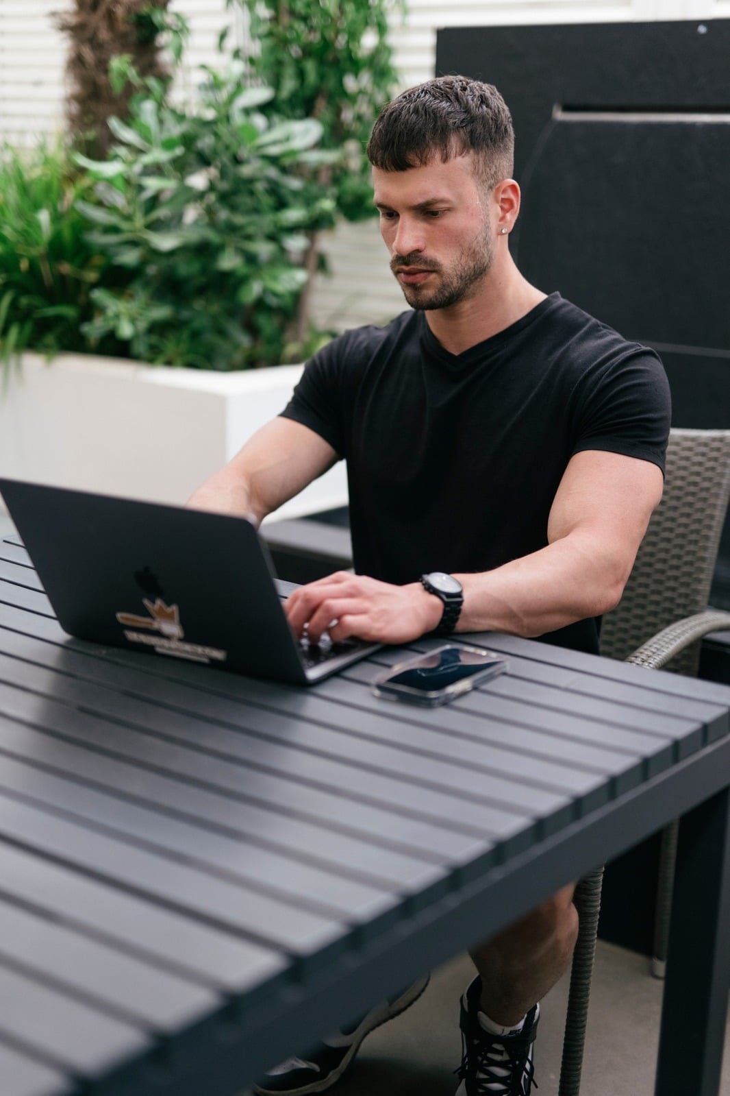 Founder working on laptop outdoors